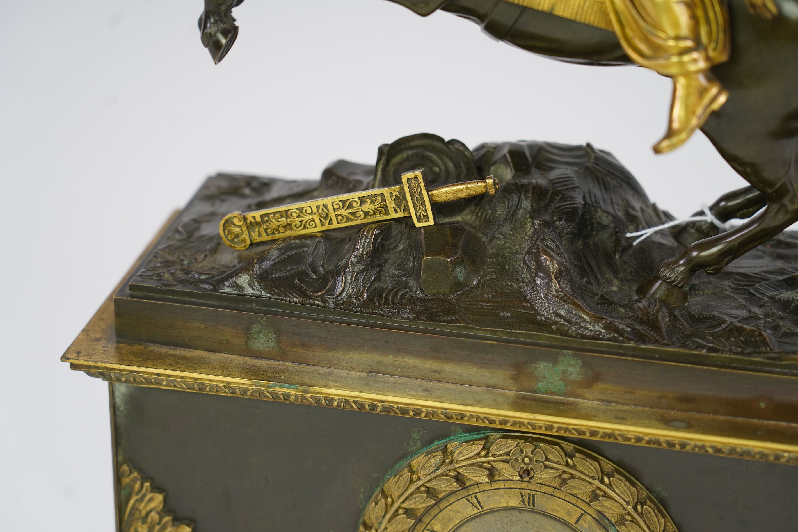 A late nineteenth century brass and bronze cased clock, mounted with a part gilt bronze of a mounted Turkish soldier and woman